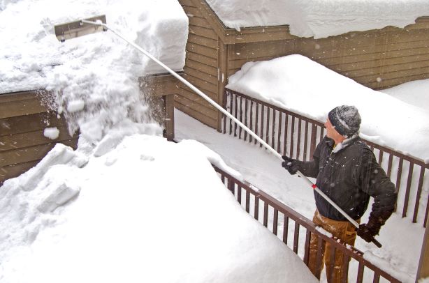 Clearing snow covered roof, Clio Michigan